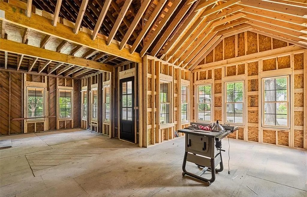 Interior of a North Carolina home under construction, showing exposed framing and roof beams